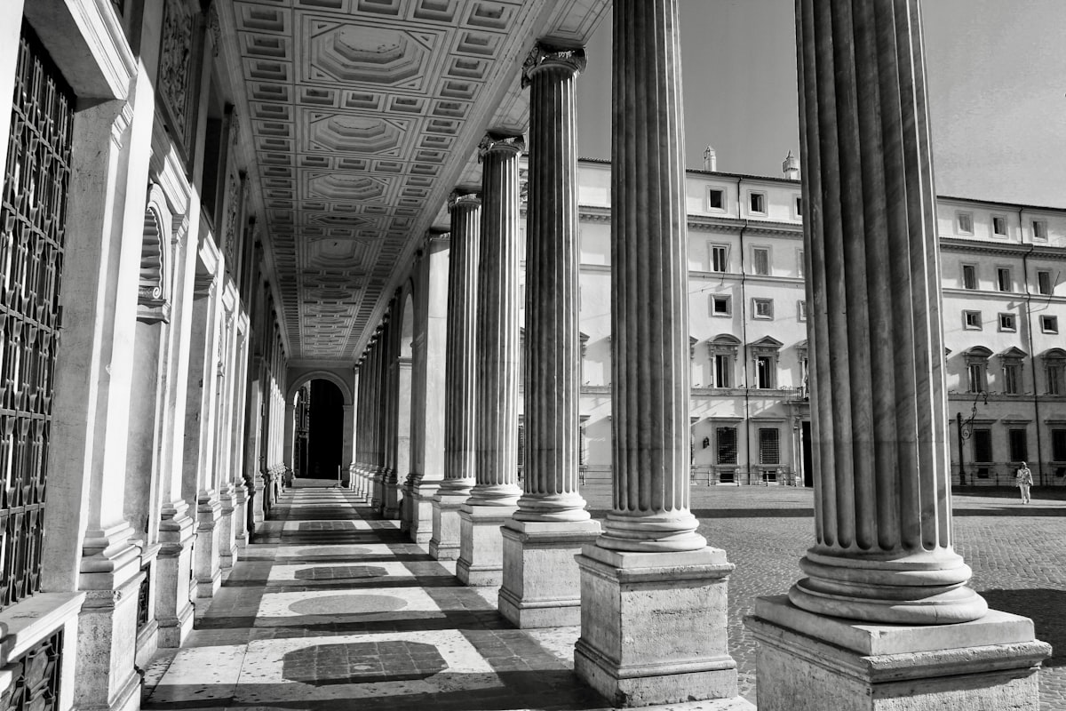 black and white photograph of columns and a building