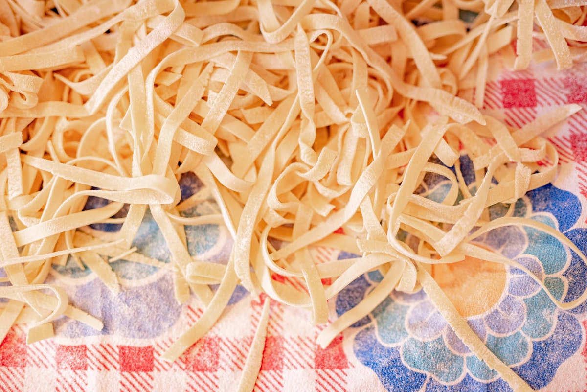 white pasta on blue and white floral textile